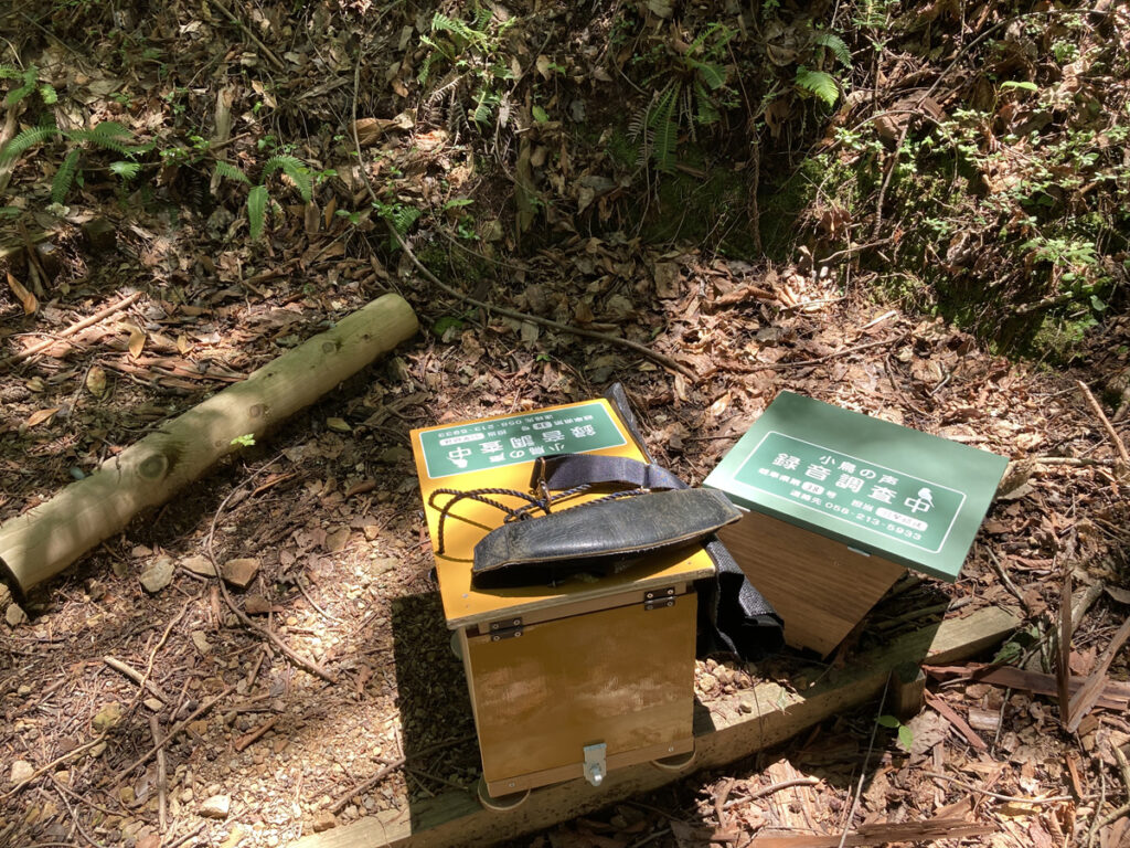 A home-made wooden box holding a sound recorder, left out overnight in the hills